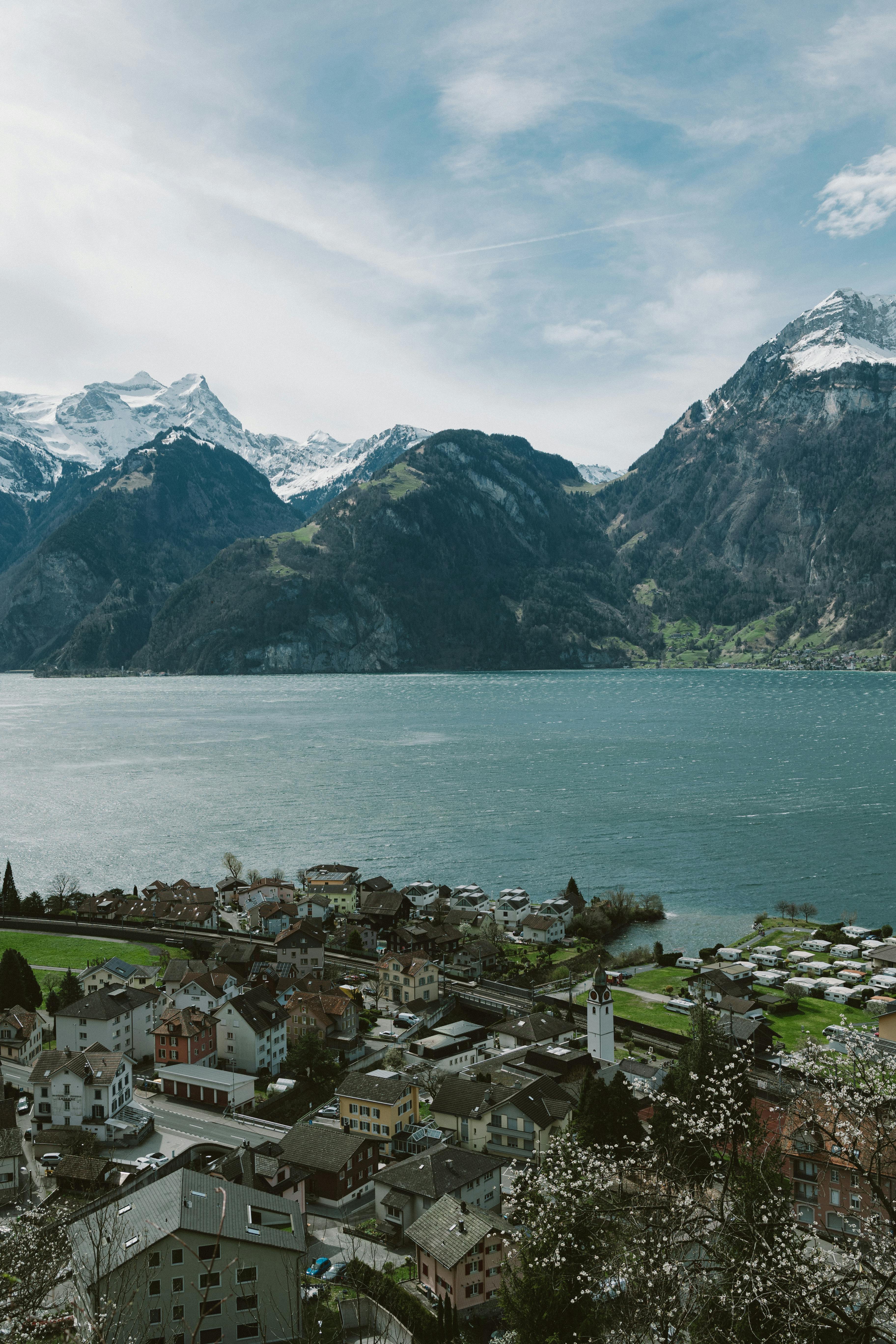 A breathtaking aerial view of Lake Lucerne and the surrounding Swiss Alps, showcasing the picturesque village below.