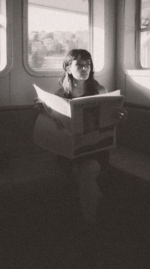 Free Black and white portrait of a woman reading a newspaper on a ferry in Istanbul. Stock Photo