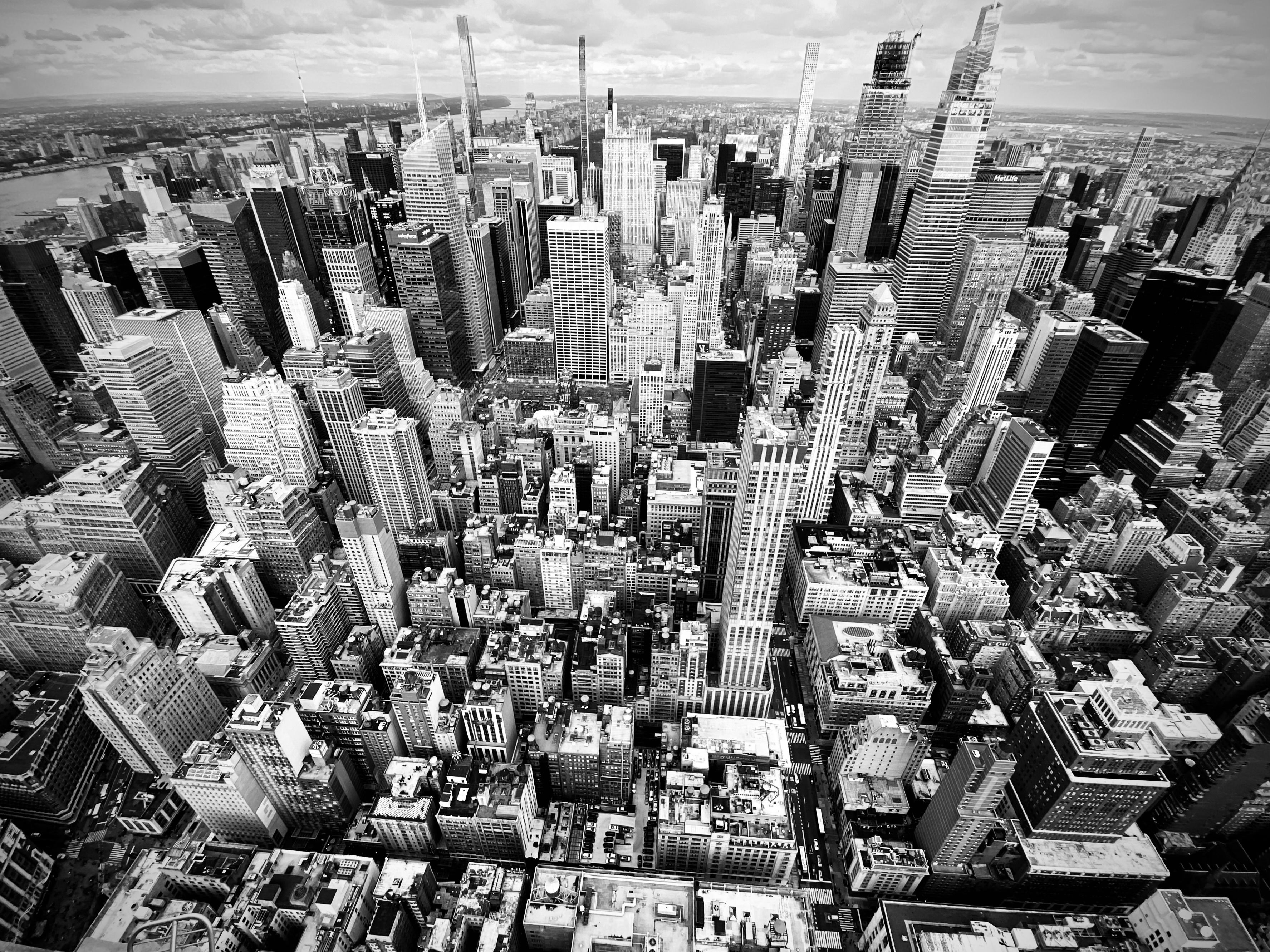 Spectacular 10-Minute Helicopter Transfer from Manhattan to Newark Airport Review Review 2026 - Monochrome aerial shot of Manhattan's bustling skyline, showcasing towering skyscrapers and urban density.