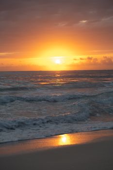 Beautiful sunset over the waves at Punta Cana beach in Dominican Republic.
