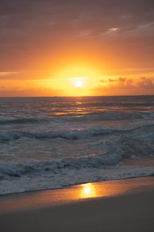 Free Beautiful sunset over the waves at Punta Cana beach in Dominican Republic. Stock Photo
