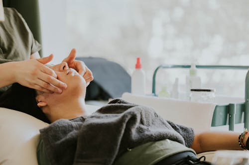 A woman getting a facial treatment in a hospital