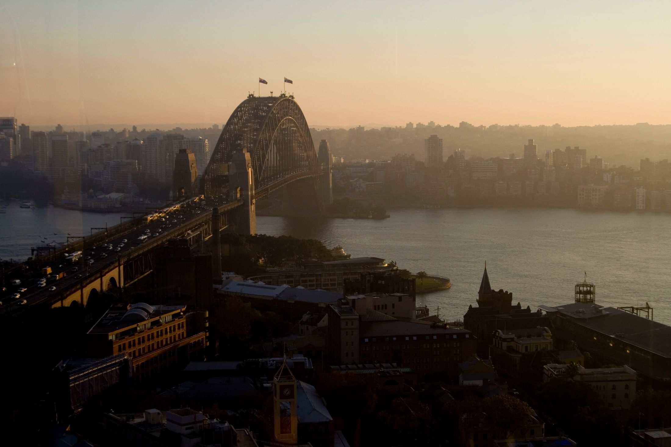 Sydney Harbour Bridge and city skyline at sunset