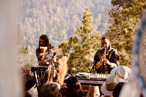 A man playing music on a keyboard in front of a crowd