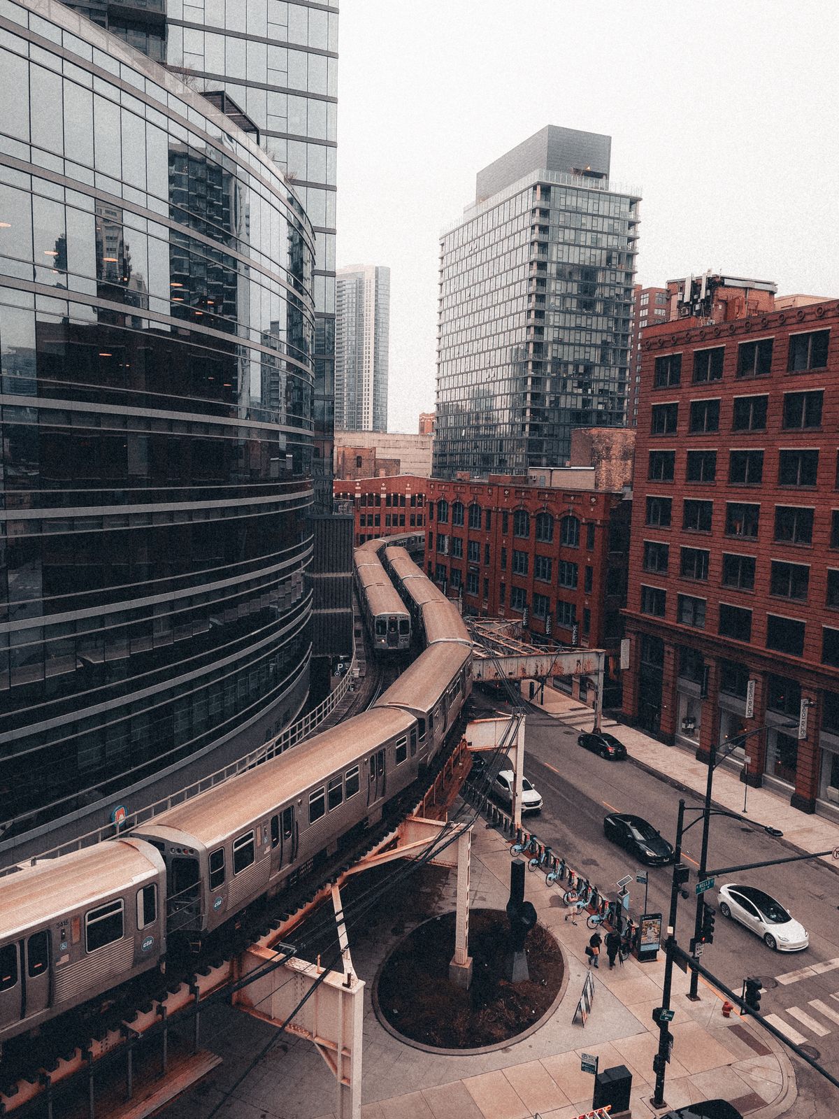 Aerial view of a train curve amidst skyscrapers in downtown Chicago.
