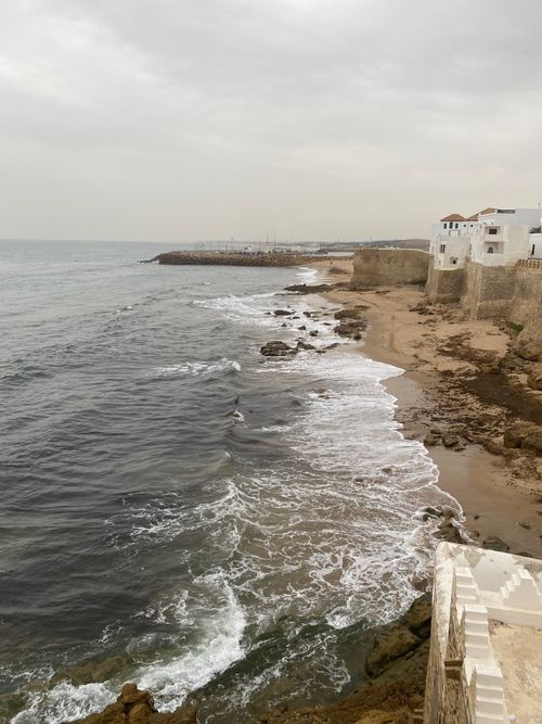 Free A beautiful view of an ocean shoreline with waves and rocky seashore in Morocco. Stock Photo