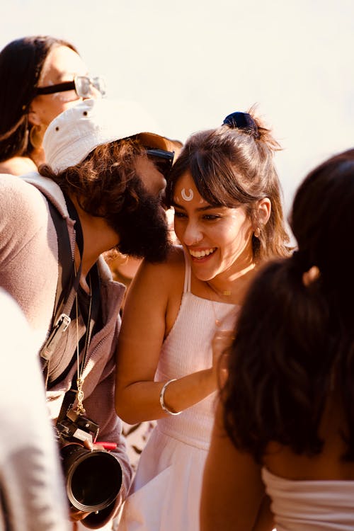 Free A woman is kissing a man while he is smiling Stock Photo