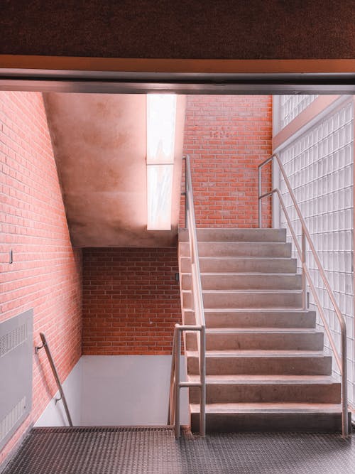 A stairway leading to a brick wall with a light