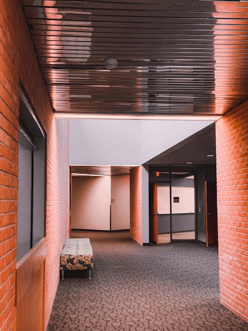 A hallway with brick walls and a door