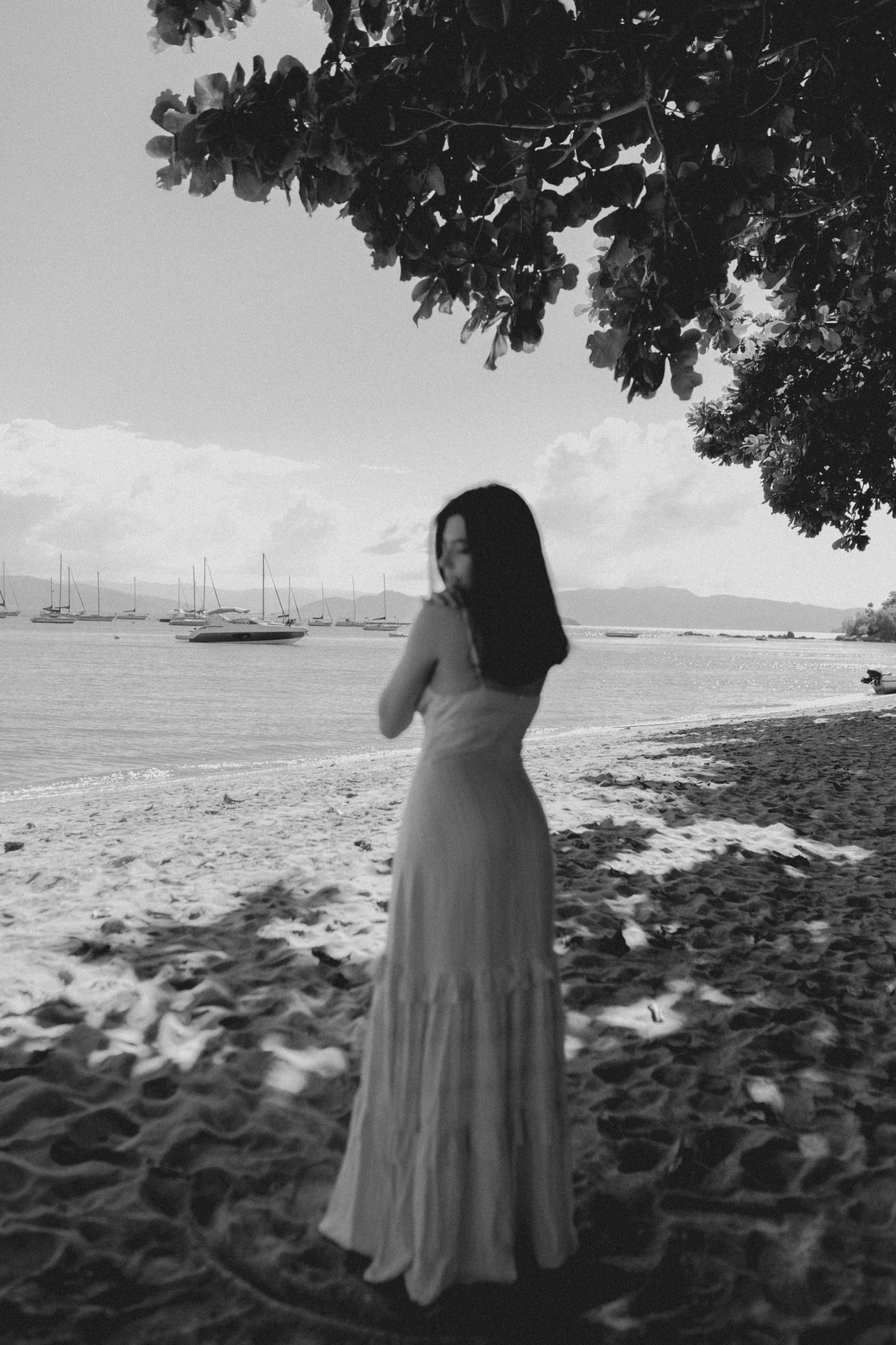 Black and White Photo of a Woman in a Dress Standing on a Beach  Free  Stock Photo