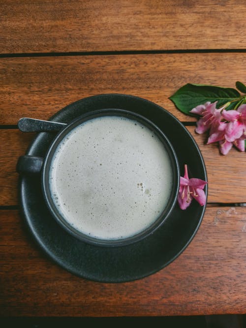 A cup of coffee with a flower on top