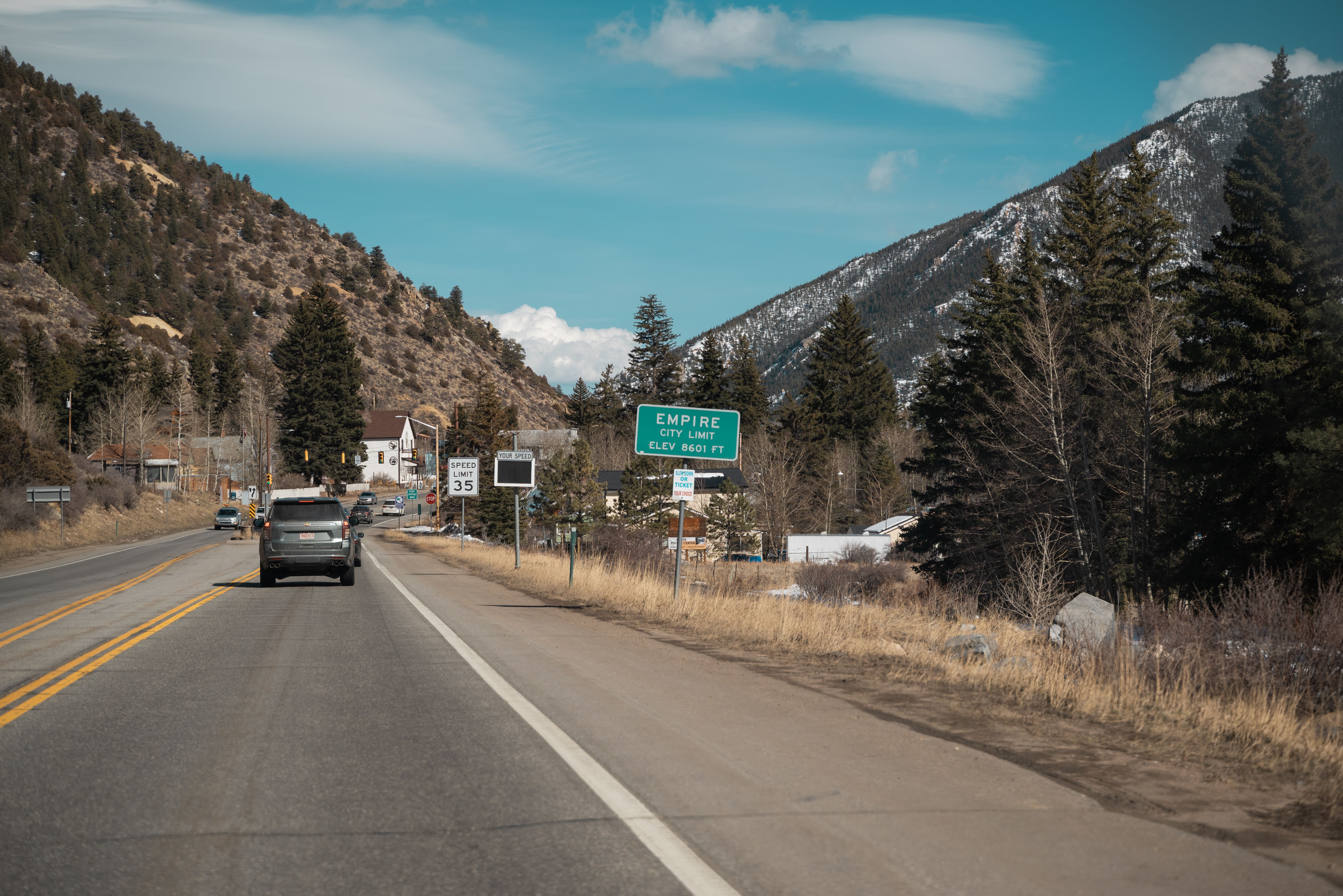 Scenic drive on mountain road towards Empire, Colorado under a clear blue sky.