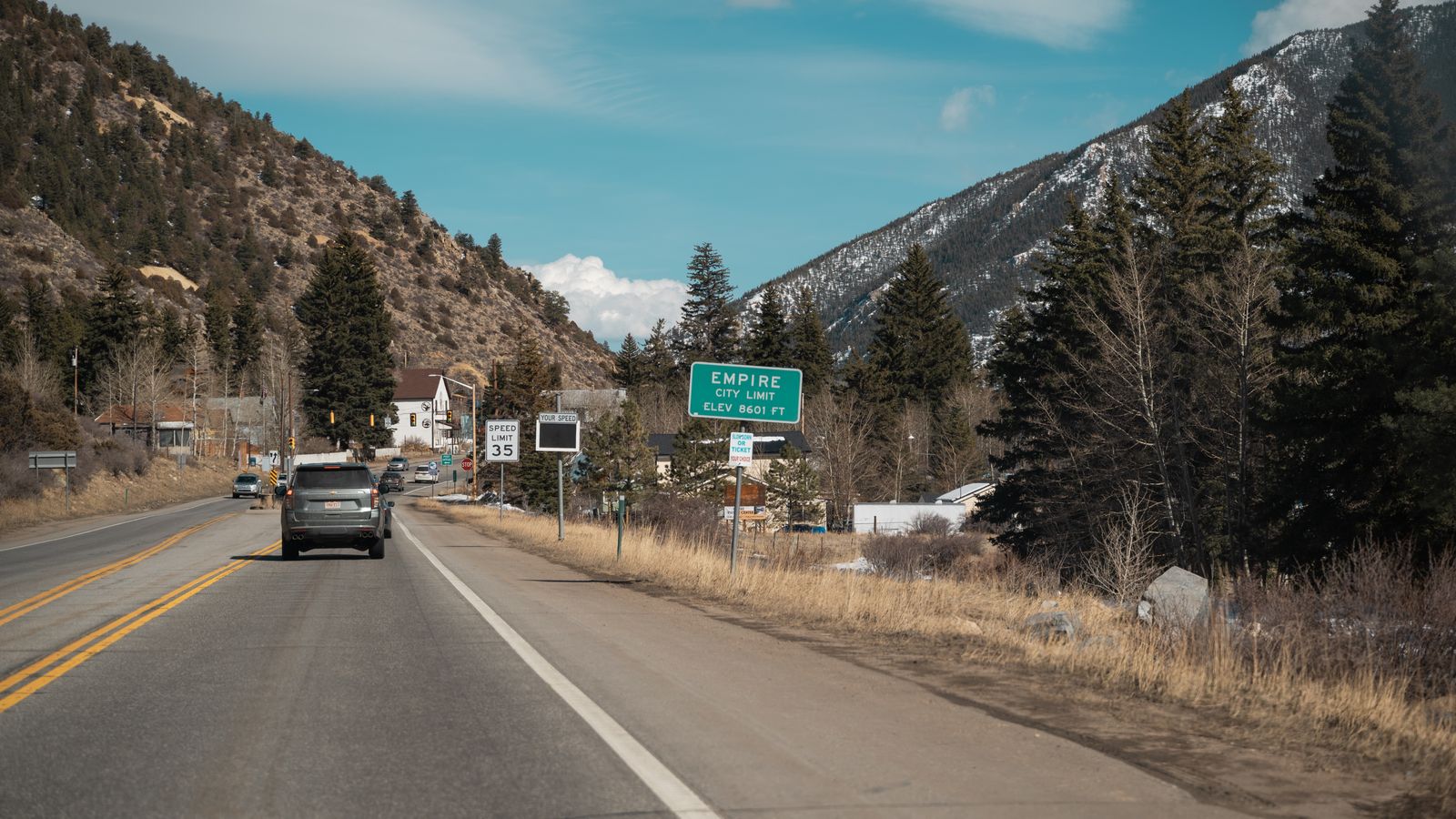 Scenic drive on mountain road towards Empire, Colorado under a clear blue sky.