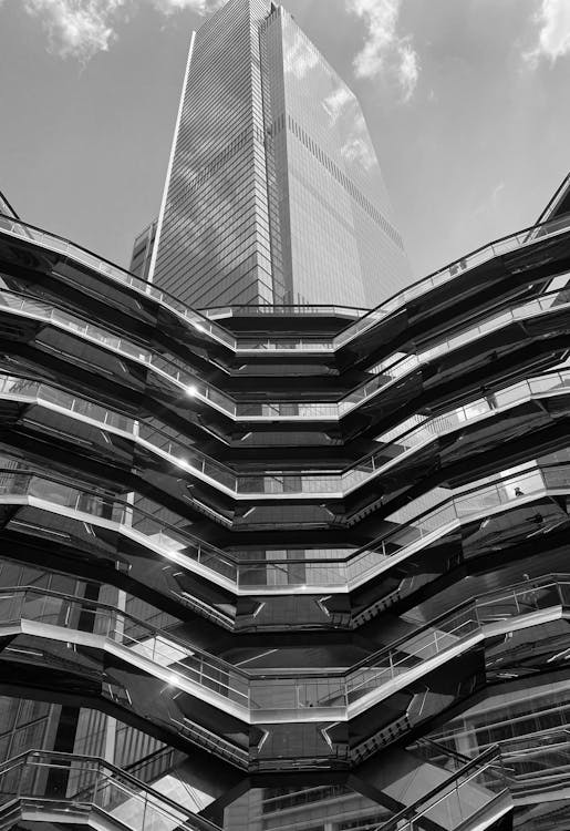 Black and white photo of a building with a lot of glass