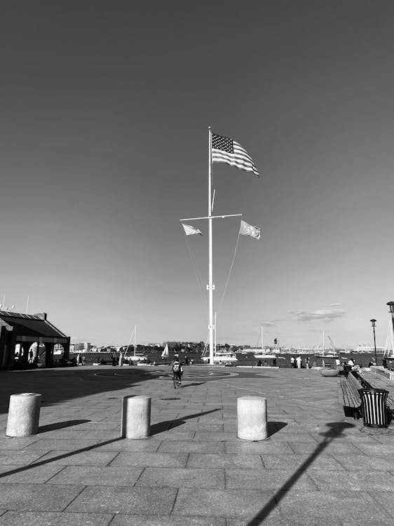 A black and white photo of a flag pole