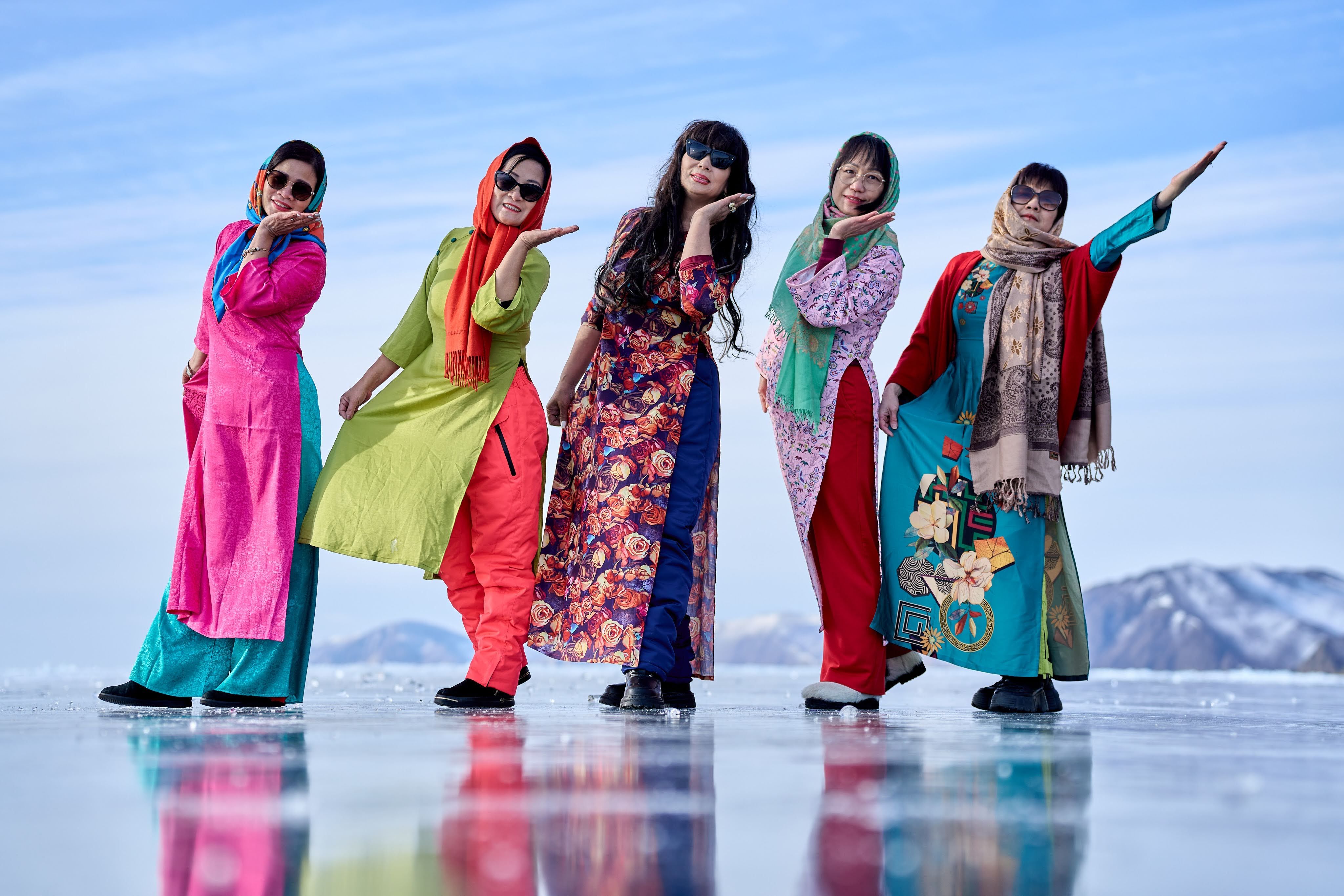 A Group of Women in Colorful Traditional Clothing Standing on a Frozen ...