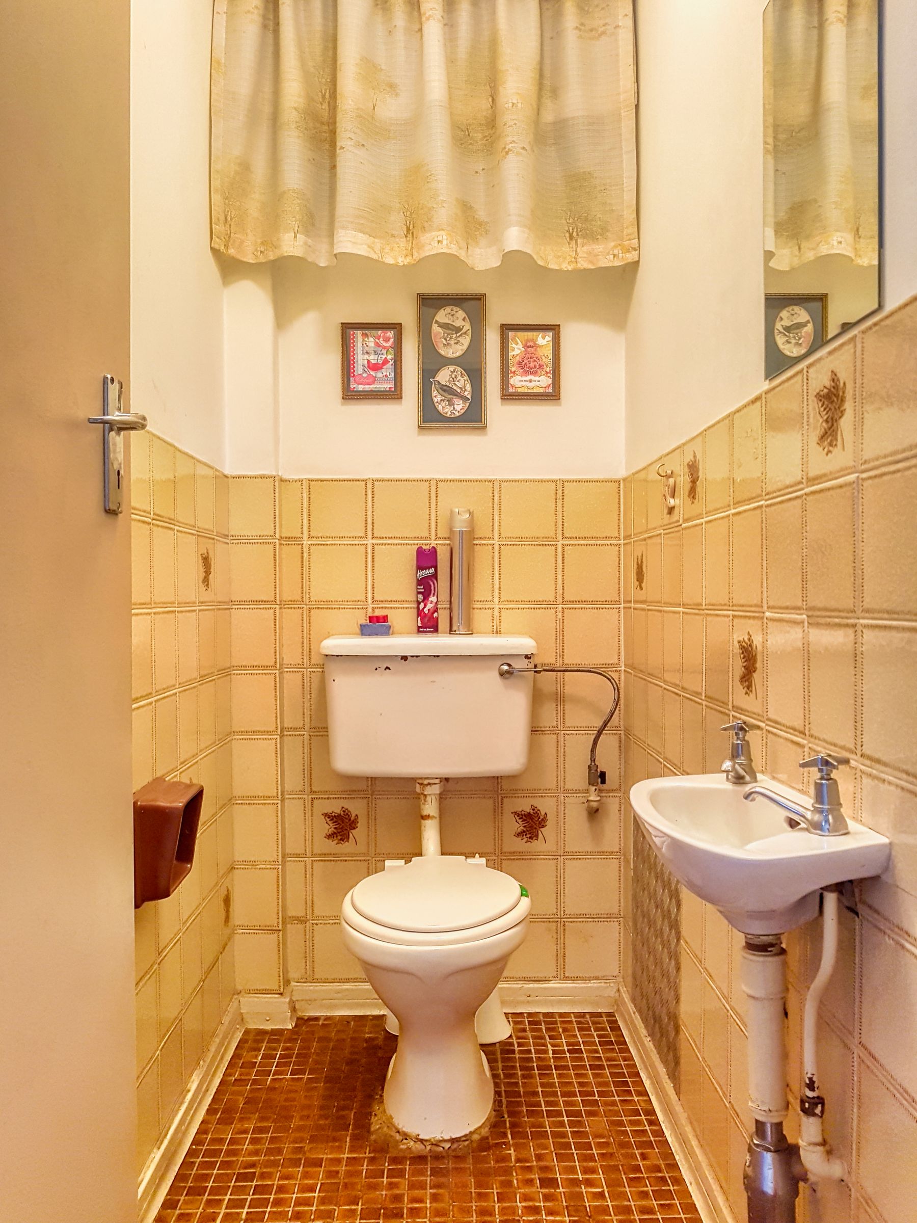 Compact bathroom with small-format wall tile, a classic basin and restrained vintage details