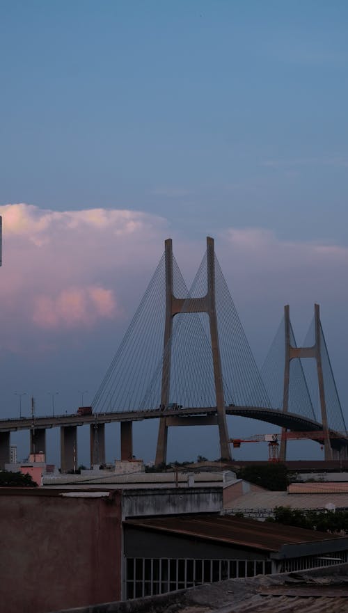 A bridge over a river with clouds in the sky