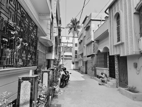 A black and white photo of a narrow alley