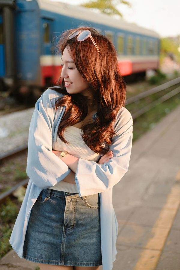 Woman in a slouchy cardigan with an A-line denim mini skirt