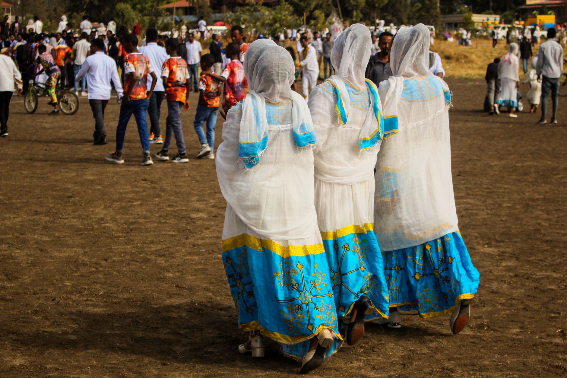Women in colorful traditional dresses celebrating the Meskel Festival in Addis Ababa, Ethiopia.
