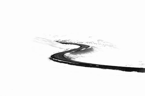 A black and white drawing of a curved road