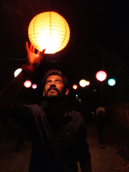 Man Holding Lighted Lantern