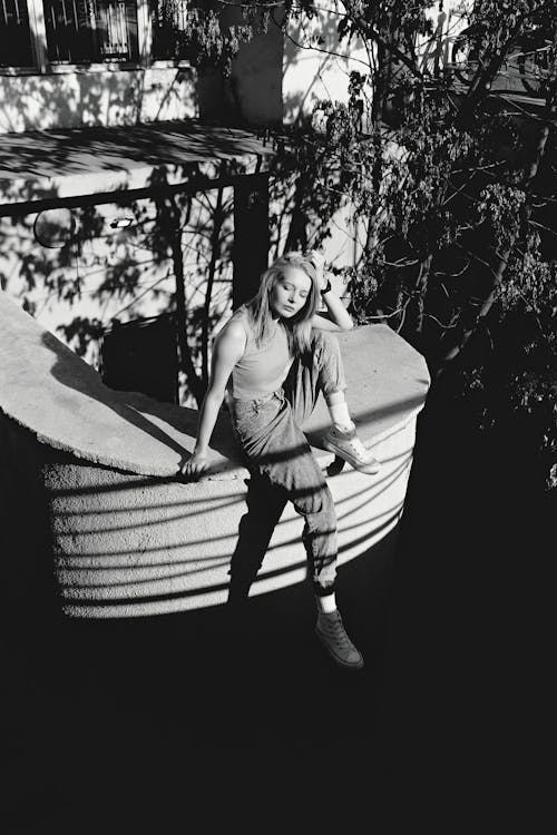 A woman sitting on a boat in a black and white photo