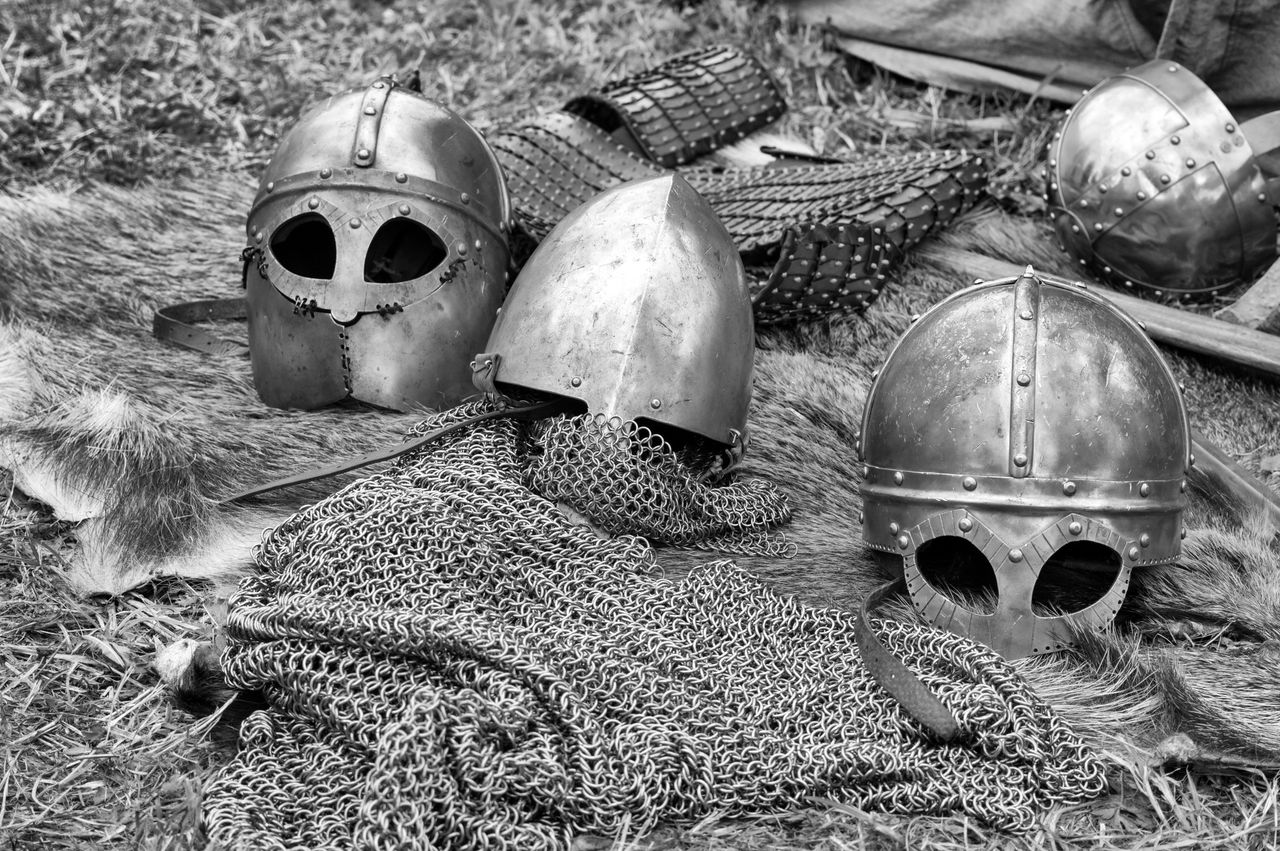 close up of historical medieval helmets and armor in black and white