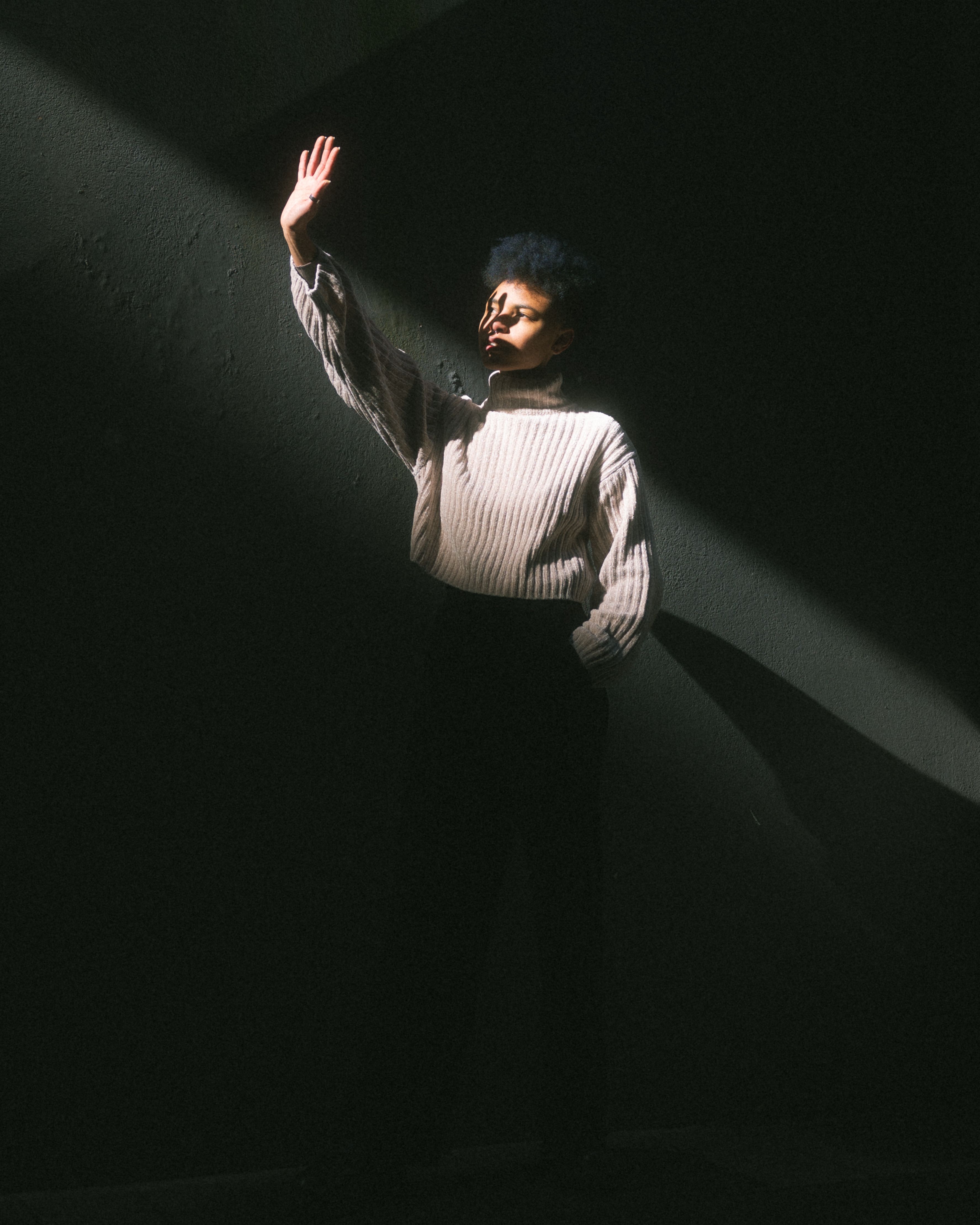 A Woman Standing in a Dark Room · Free Stock Photo