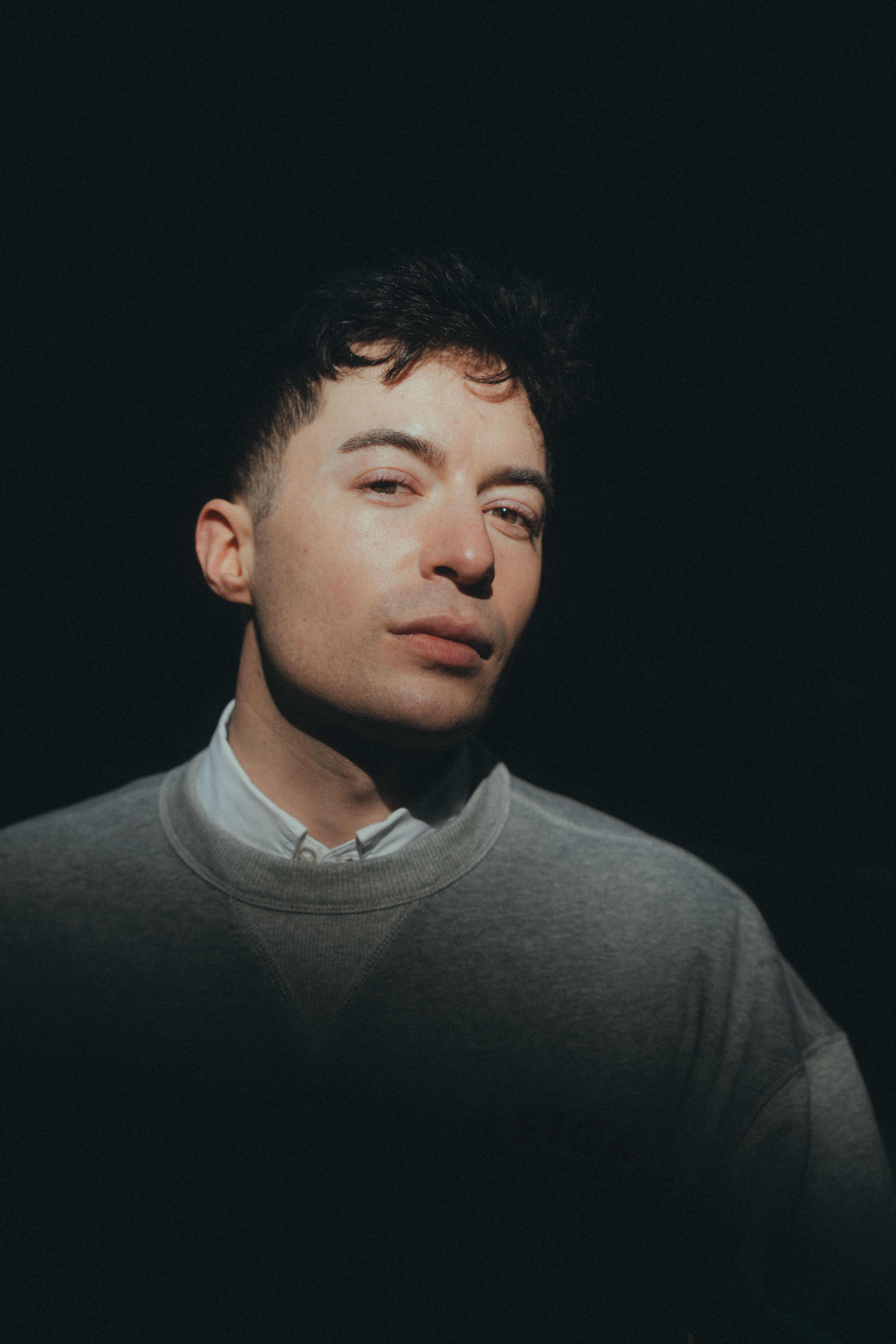 Free Portrait of a man with dramatic lighting highlighting fashion elements in a studio setting. Stock Photo