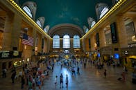 纽约市繁忙的大中央车站广角视图，人群和标志性的美国国旗映入眼帘