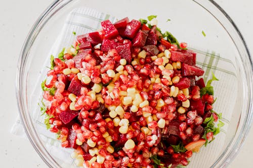 A bowl filled with beets, corn and other ingredients