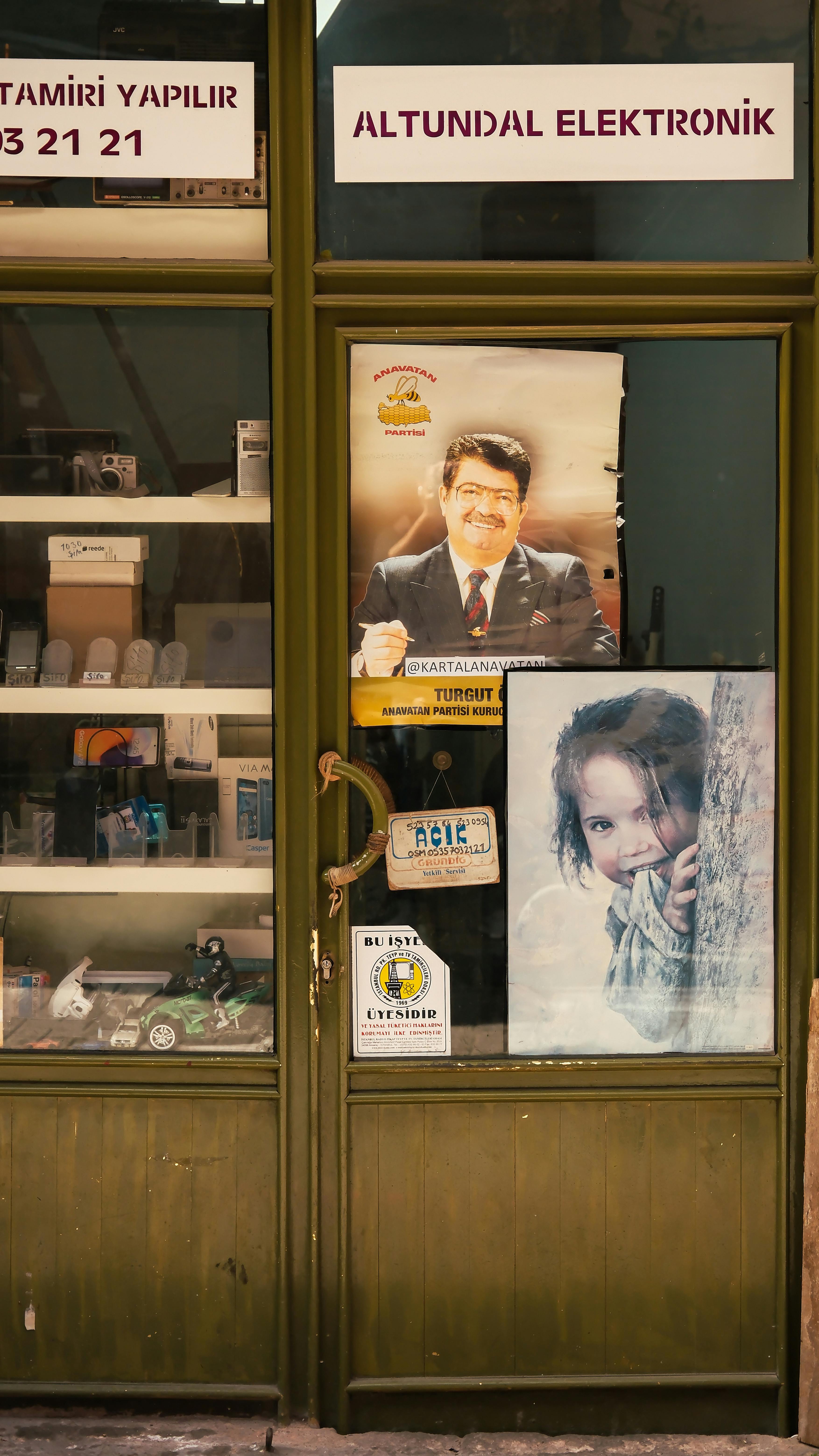 Vintage electronic shop with window posters showcasing a woman and child.