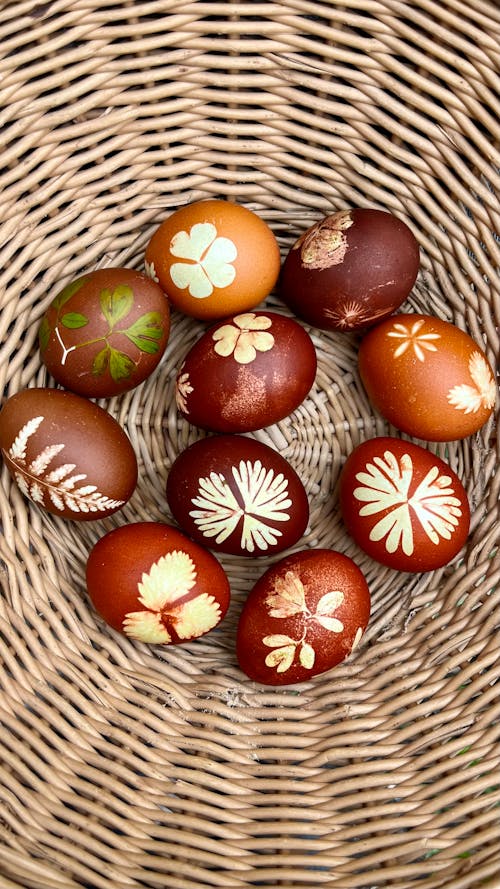 A basket with painted eggs in it