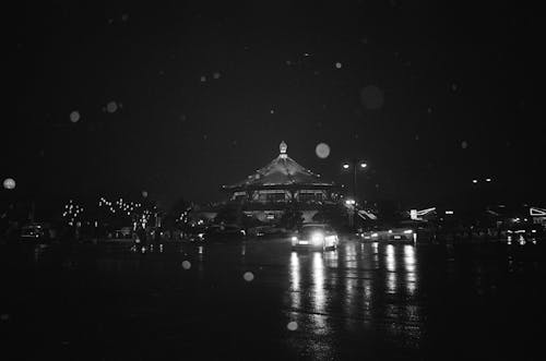 A black and white photo of a building at night