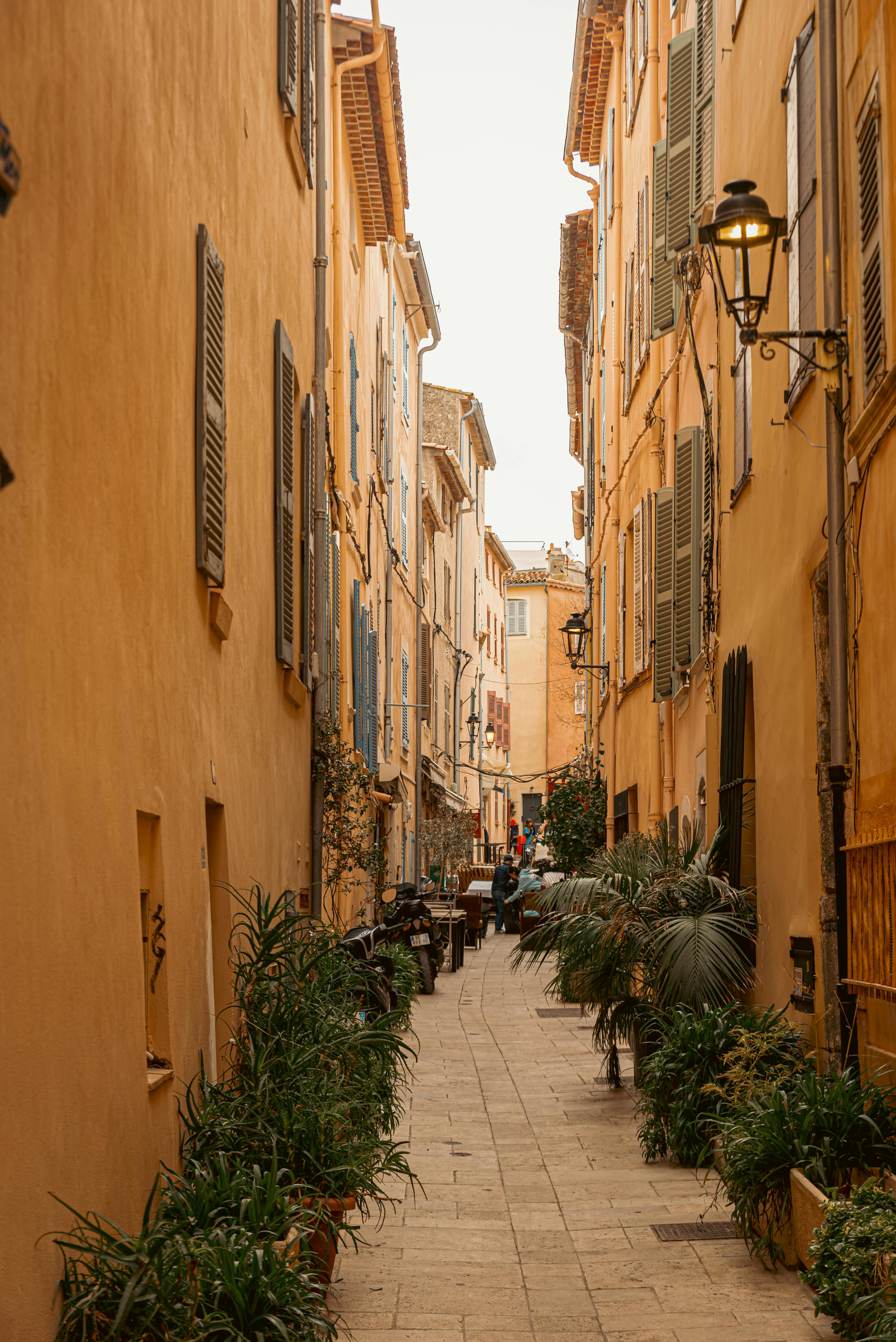 Quaint alleyway with shutters in Saint-Tropez, perfect for exploring Mediterranean charm.