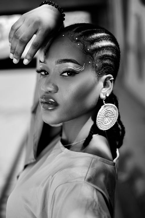 Black and White Photo of a Young Woman with Braided Hair Wearing Dangling Earrings