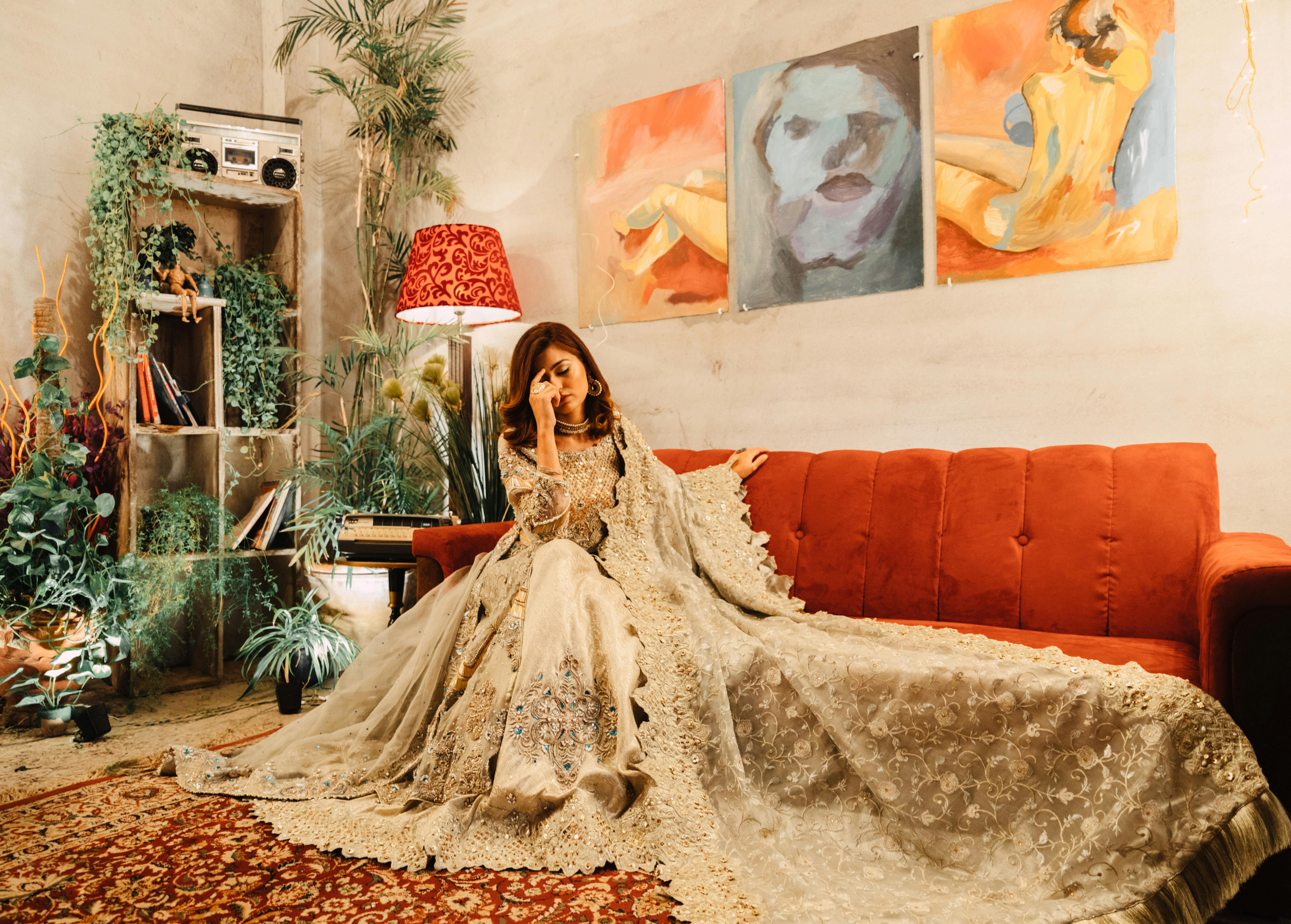 woman wearing brown dress sitting on sofa