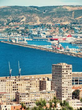 Aerial view of Marseille port showcasing urban cityscape and waterfront.