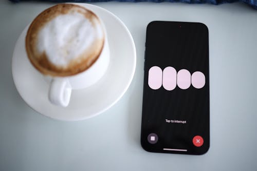 A phone with a coffee cup and a message on it