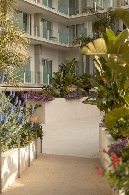 Beautiful greenery and vibrant flowers on a luxury hotel patio in Calafell, Spain.
