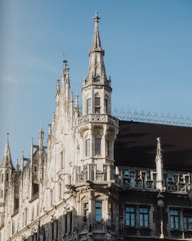 Stunning Gothic architecture of a historic building in Munich, Germany, bathed in sunlight.