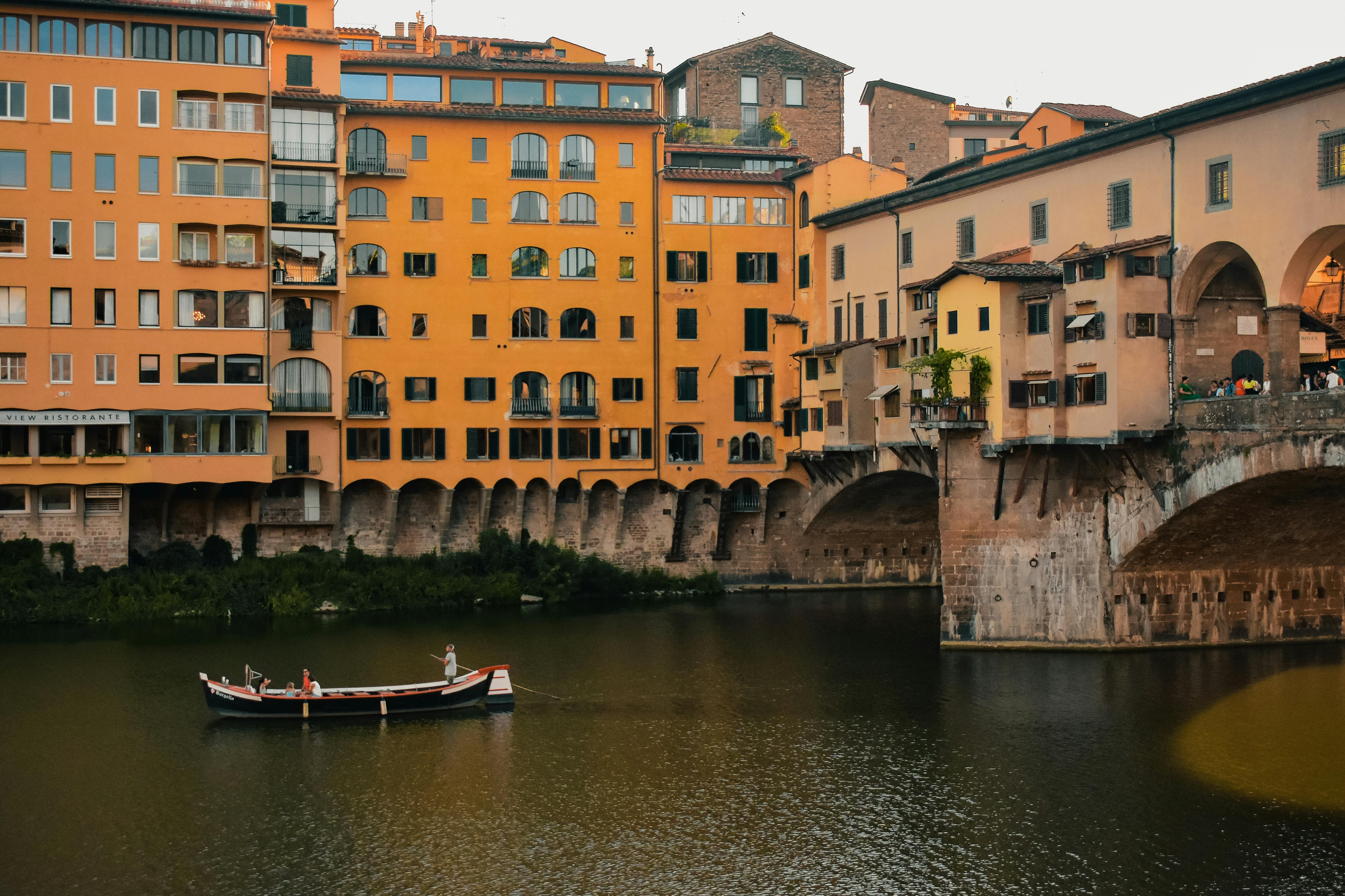 A boat is floating in the water near some buildings