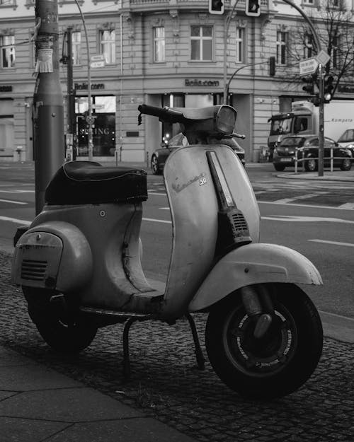 A black and white photo of a scooter on the street