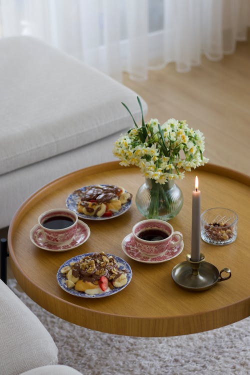 Cups of Coffee and Plates with Dessert on Coffee Table