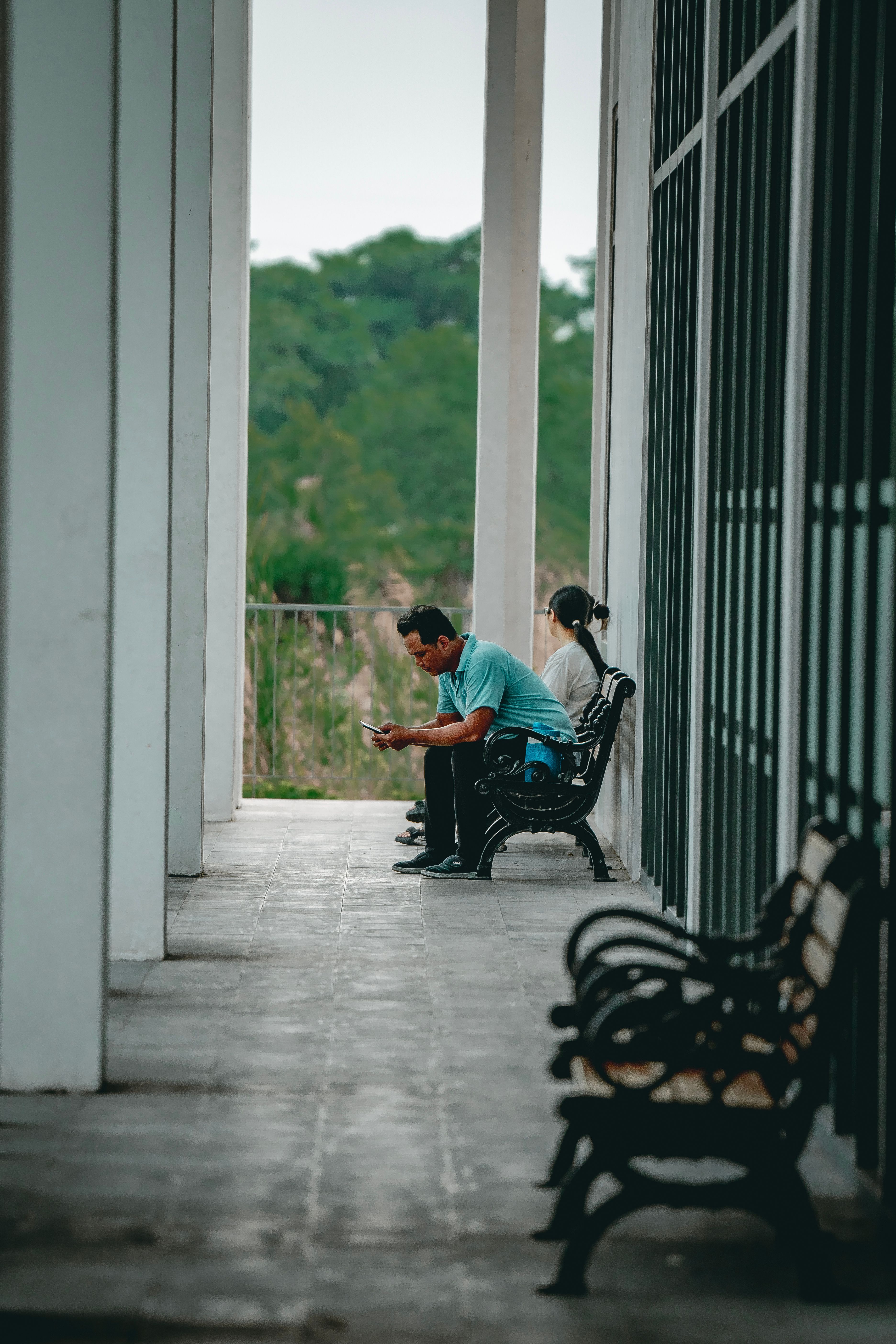 People Sitting on Wooden Bench in Front of a Building · Free Stock Photo