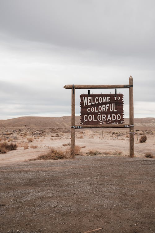 A Sign Saying "Welcome To Colorful Colorado" Standing in a Desert