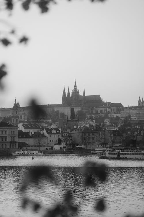 A black and white photo of a city with a river