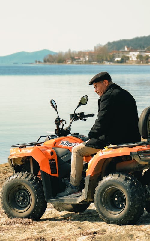 A man sitting on an atv near the water